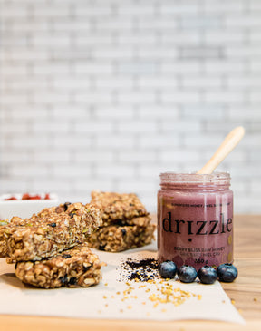 berry bliss honey on a cutting board beside granola bars