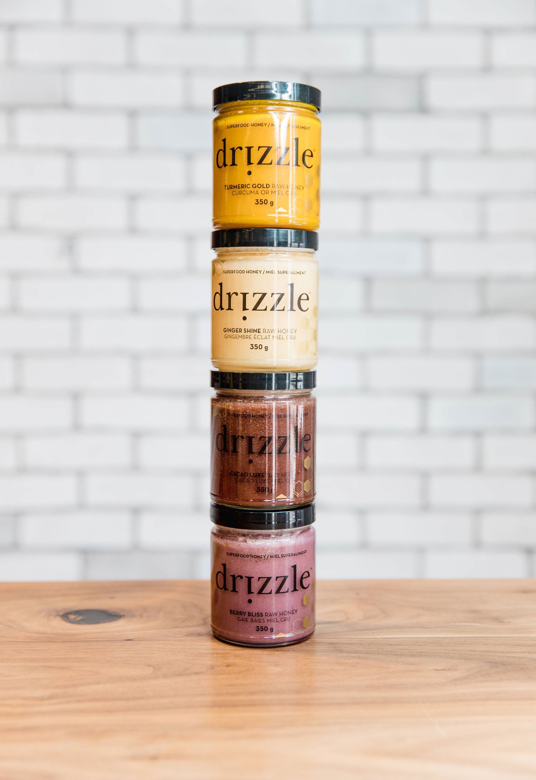 four honey jars stacked on a kitchen counter