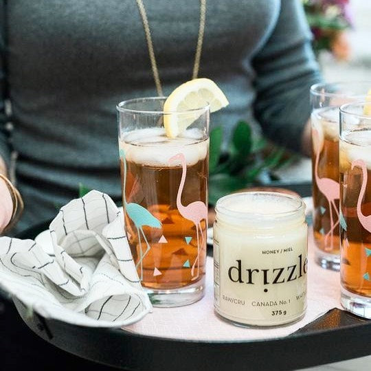 jar of honey open beside a glass of ice tea