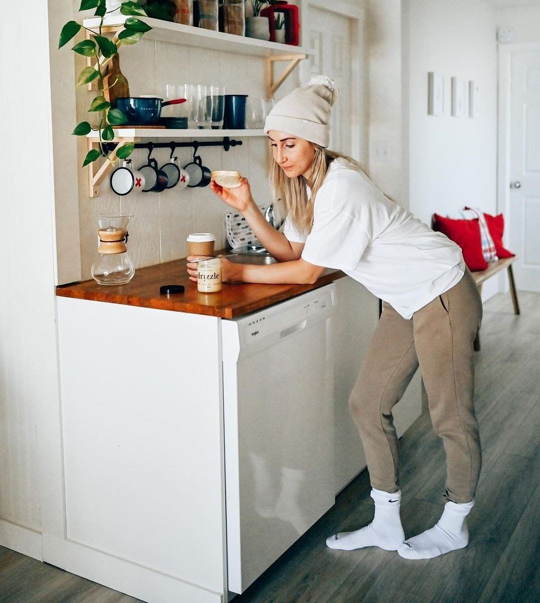 women eating honey out of the jar at the kitchen counter