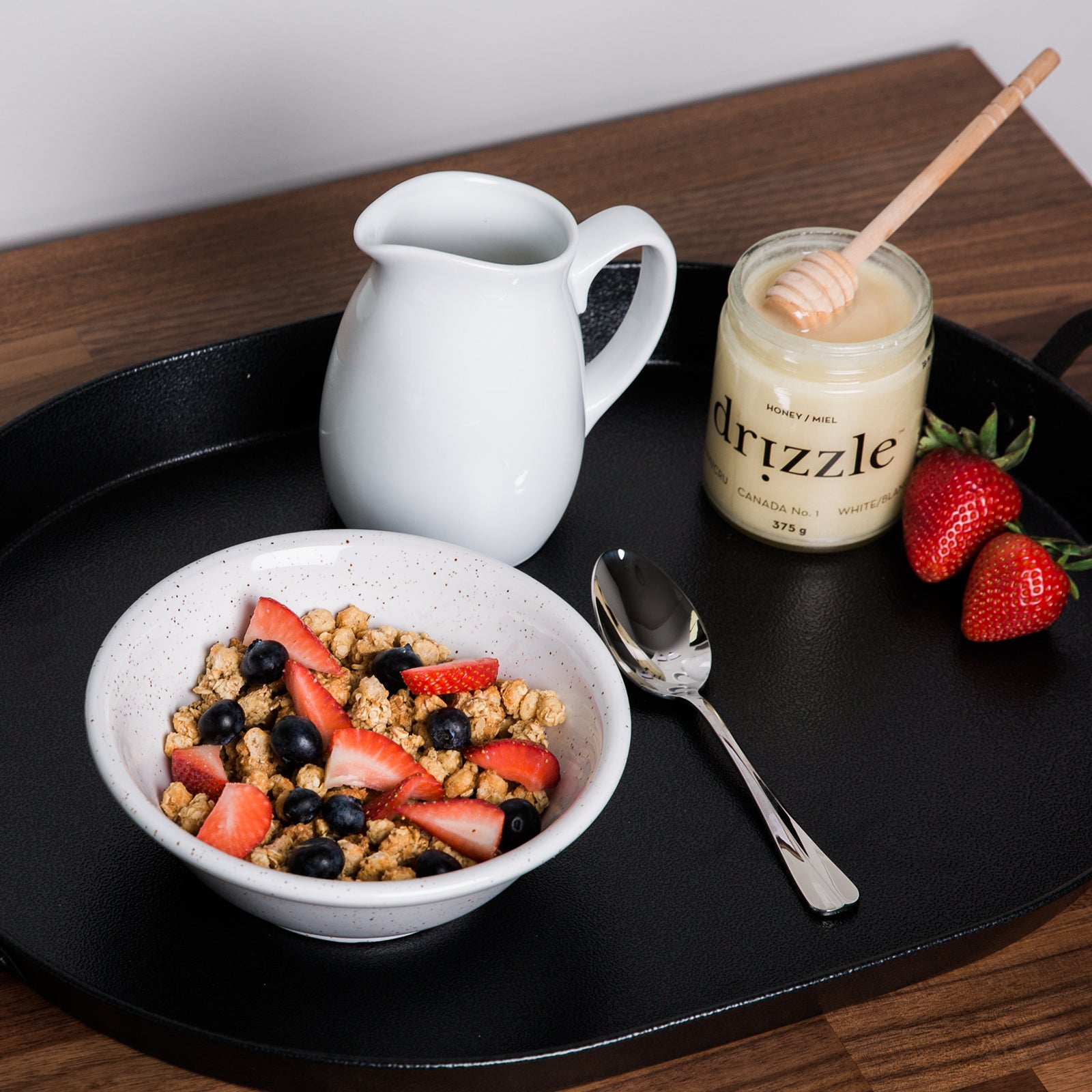 jar of open honey by a bowl of oatmeal