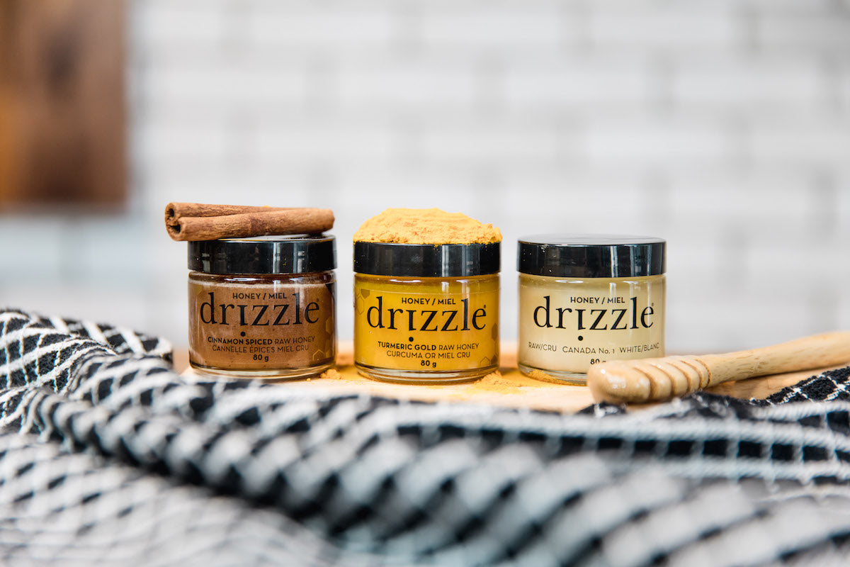 Drizzle Taster Trio next to a drizzle spoon and raw ingredients.