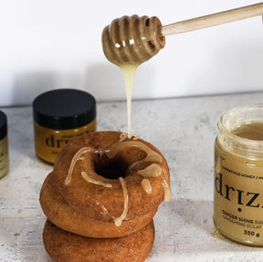 honey being drizzled onto donuts