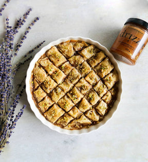 Jar of honey beside a pie
