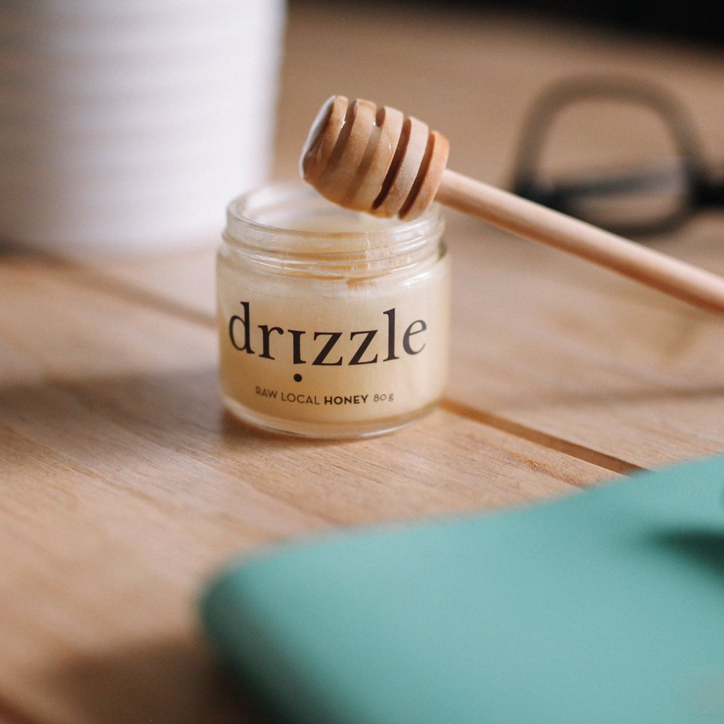 Drizzle Mini White Raw Honey with a drizzle spoon.