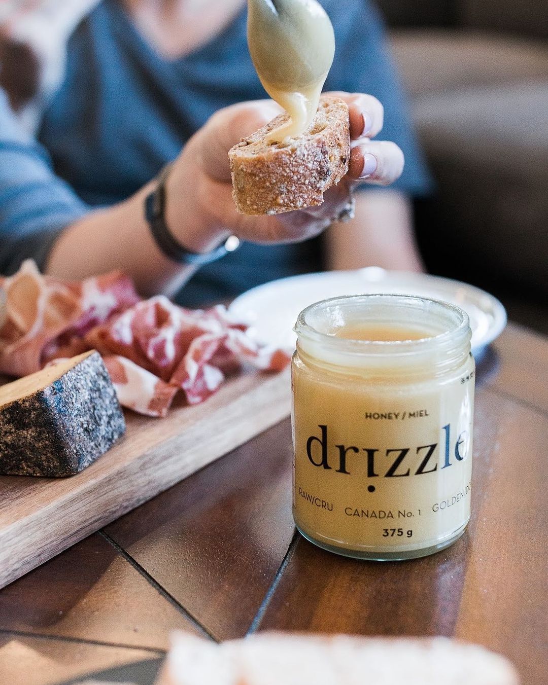 Honey being spread on a piece of bread