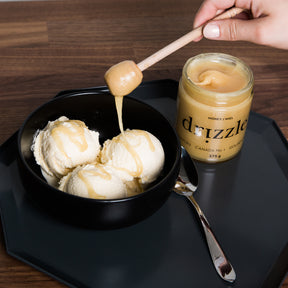 Drizzle Golden Raw Honey next to icecream in a bowl being drizzled with honey.